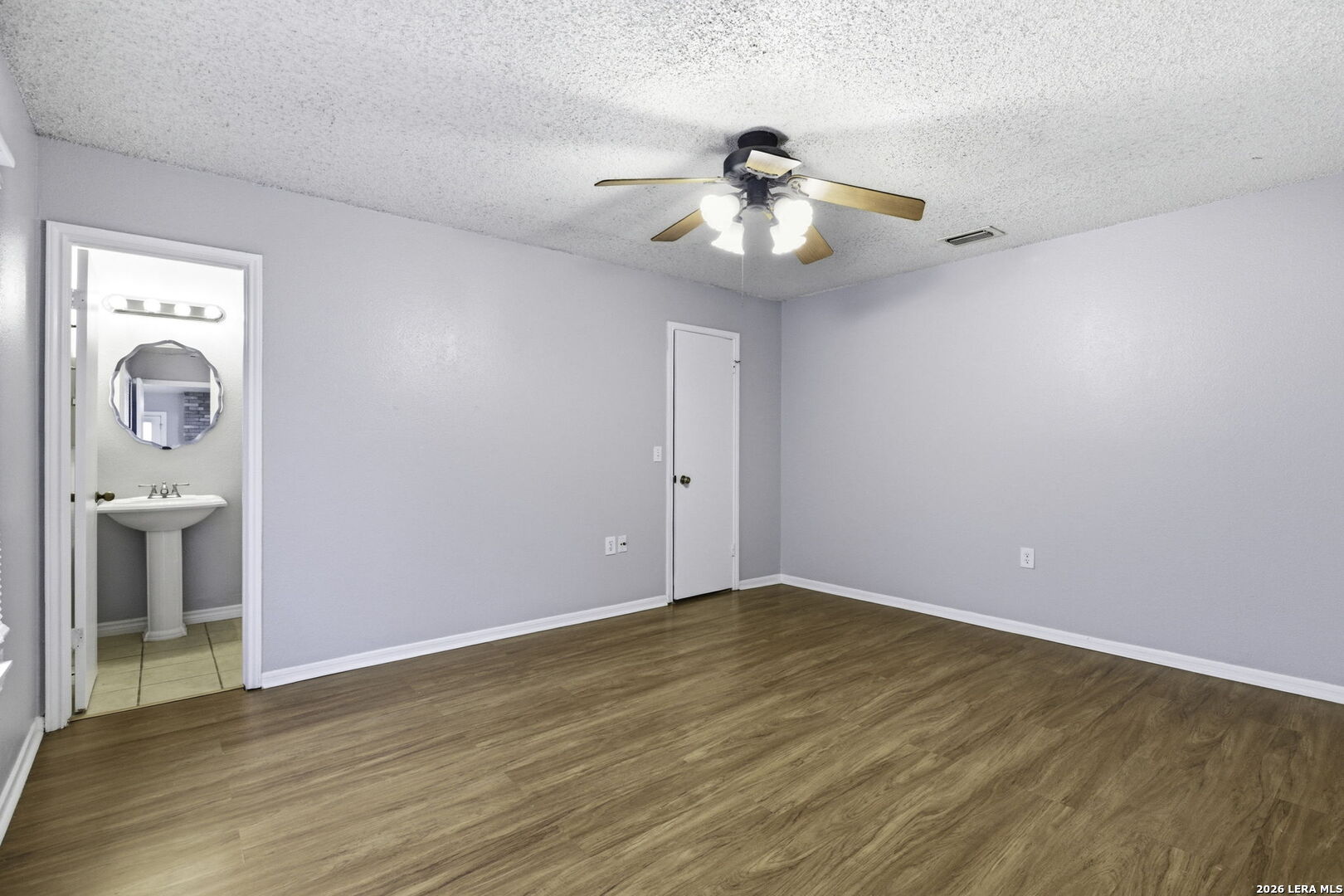 9439 Charter Point San Antonio, TX 78250 - Photo 8 of 14 wooden floor in an empty room with a window