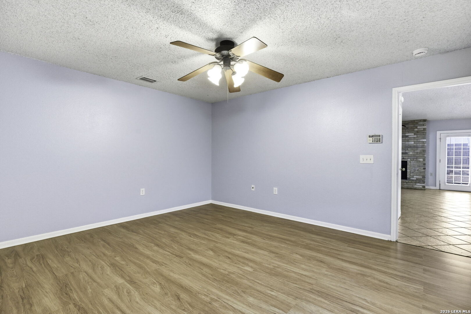 9439 Charter Point San Antonio, TX 78250 - Photo 9 of 14 a view of an empty room with wooden floor