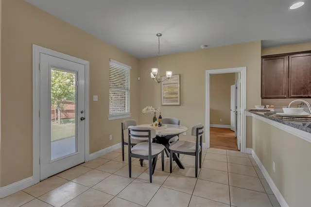 a view of a dining room with furniture and chandelier