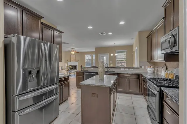 a kitchen with stainless steel appliances a refrigerator sink and stove