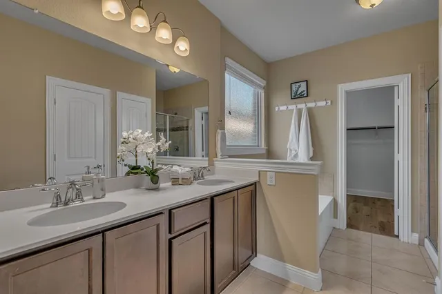 a bathroom with a double vanity sink and a mirror