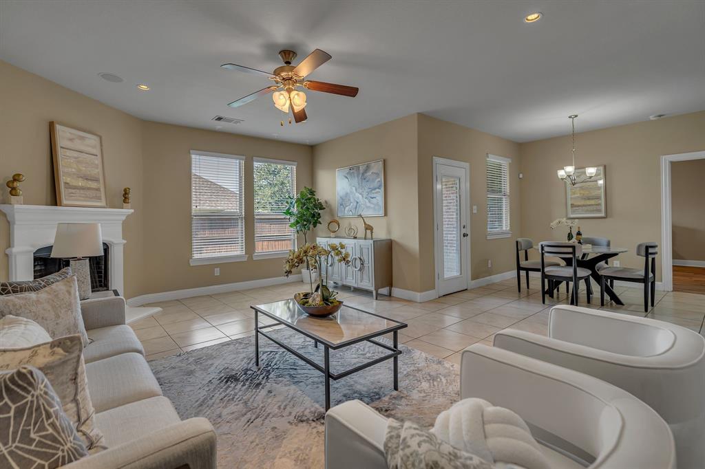 3812 Fordham Street Frisco, TX 75036 - Photo 10 of 33 a living room with furniture a fireplace and a chandelier