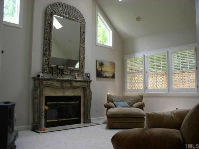 6708 Pointe Vista Circle Raleigh, NC 27615 - Photo 1 of 1 a living room with furniture a large window and a fireplace