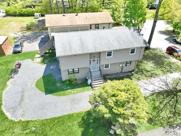 an aerial view of a house with a yard and potted plants