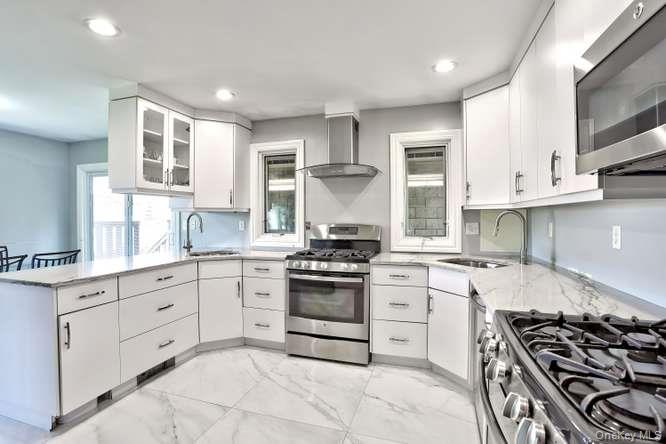 60 Brewer Road Monsey, NY 10952 - Photo 11 of 32 a kitchen with stainless steel appliances white cabinets and a stove top oven