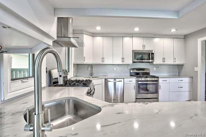 60 Brewer Road Monsey, NY 10952 - Photo 13 of 32 a kitchen with stainless steel appliances granite countertop a sink a stove and cabinets
