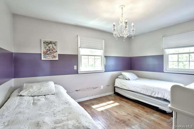 60 Brewer Road Monsey, NY 10952 - Photo 16 of 32 a bedroom with a bed and a chandelier