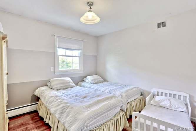 60 Brewer Road Monsey, NY 10952 - Photo 17 of 32 a bedroom with a bed and wooden floor