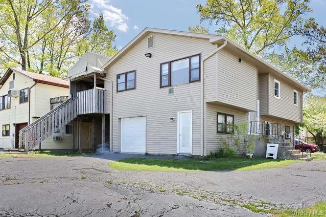 60 Brewer Road Monsey, NY 10952 - Photo 26 of 32 a view of a white house with a large space and large trees