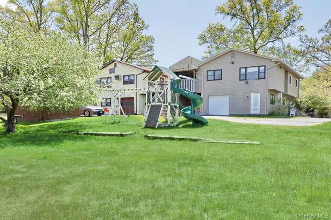 60 Brewer Road Monsey, NY 10952 - Photo 27 of 32 a front view of a house with a yard and garage