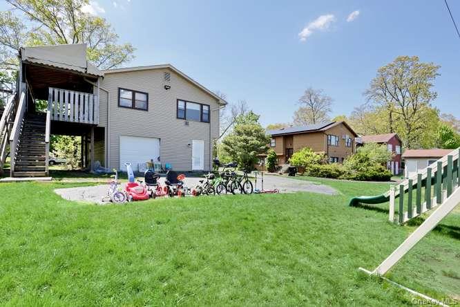 60 Brewer Road Monsey, NY 10952 - Photo 29 of 32 a front view of a house with a big yard and potted plants