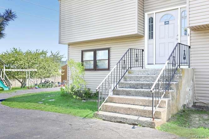 60 Brewer Road Monsey, NY 10952 - Photo 3 of 32 a view of a house with a small yard and a large tree with wooden fence