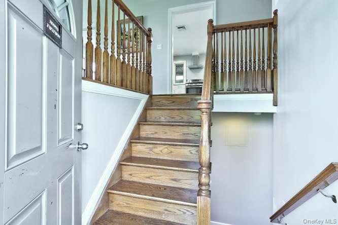 60 Brewer Road Monsey, NY 10952 - Photo 7 of 32 a view of staircase with lots of frames on wall and a window