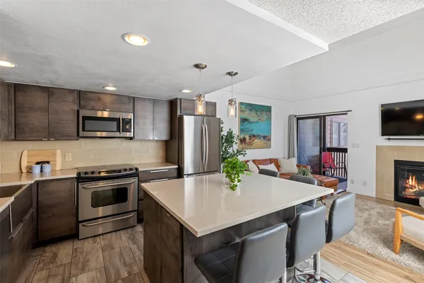 a kitchen with a stove a sink and a refrigerator