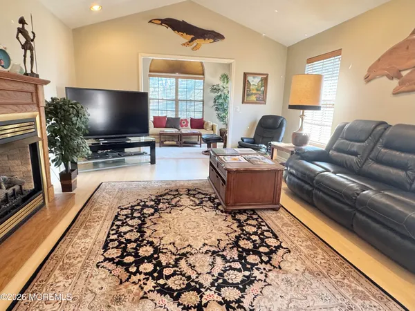 a kitchen with stainless steel appliances granite countertop a refrigerator a sink a stove and a refrigerator