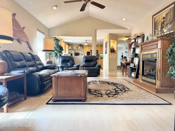 a kitchen with stainless steel appliances granite countertop a kitchen island a stove a table and chairs