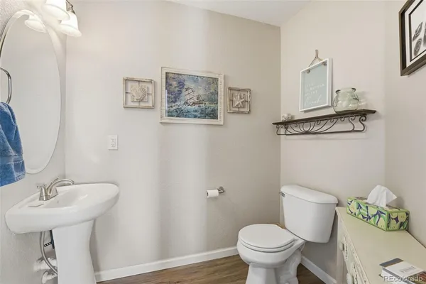 a bathroom with a toilet a sink and a mirror