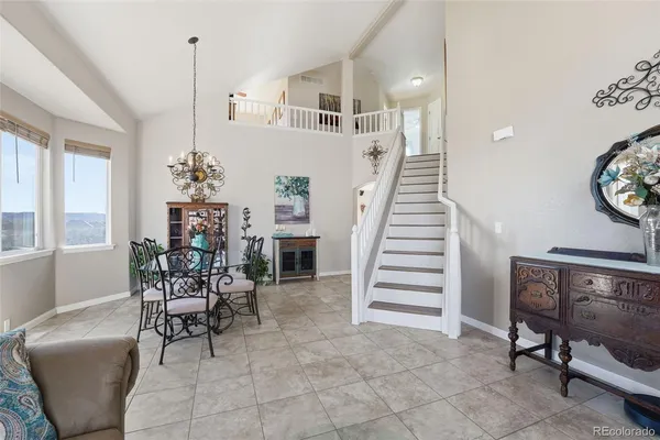 a view of a dining room with furniture and entryway