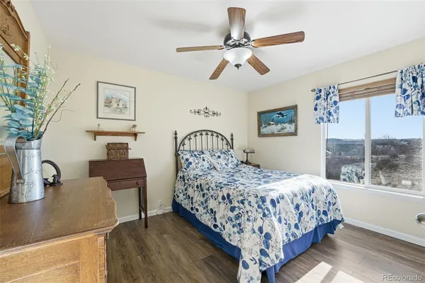 a bedroom with a bed a dresser next to a window