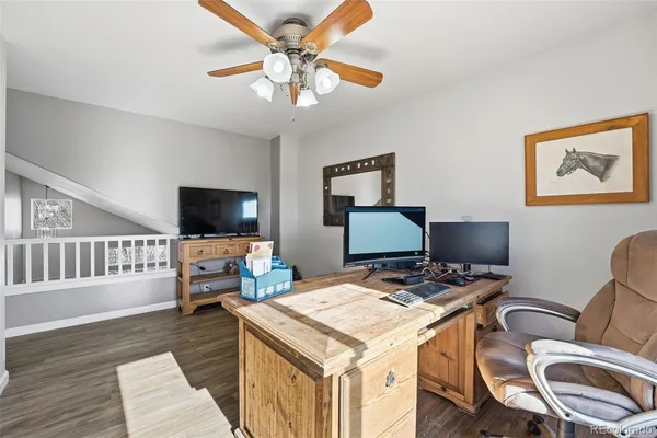 a view of a workspace with furniture and a flat screen tv