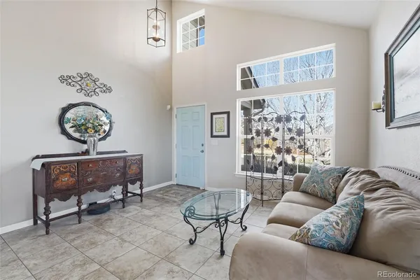 a living room with furniture and a chandelier