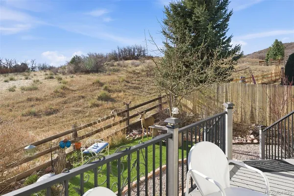 a view of a couches in the patio with a yard