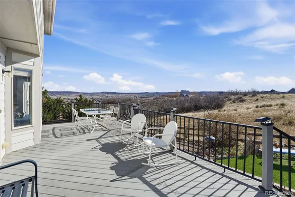 a view of a balcony with two chairs and a table