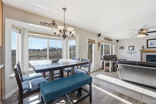 a view of a dining room with furniture wooden floor and chandelier