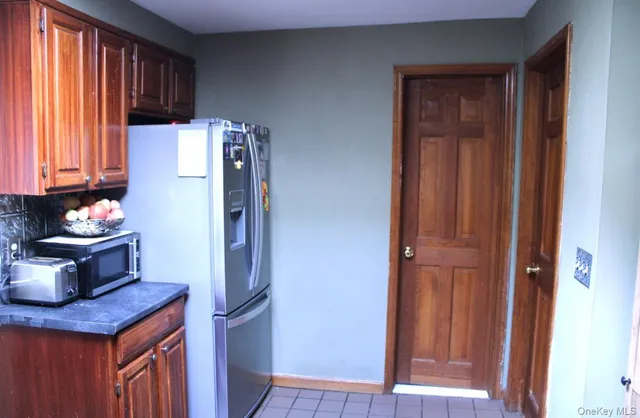 a kitchen with a refrigerator and window