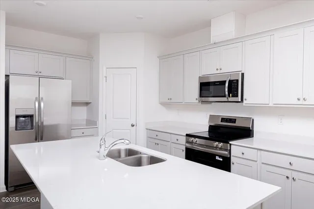 a kitchen with a sink a stove and refrigerator