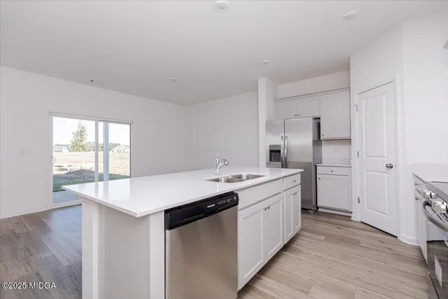 a kitchen with a sink stove and refrigerator