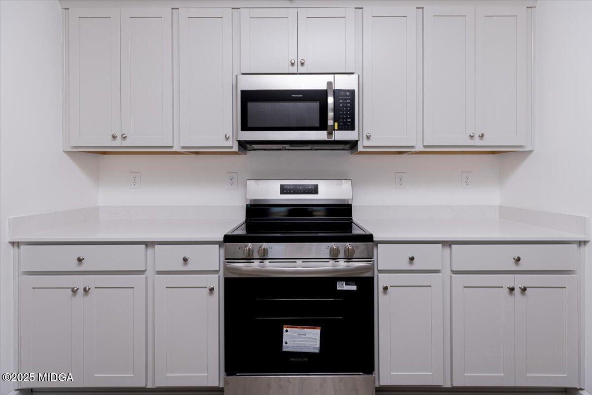 218 Hickory Rdg Trail Kathleen, GA 31047 - Photo 24 of 48 a kitchen with white cabinets and stainless steel appliances