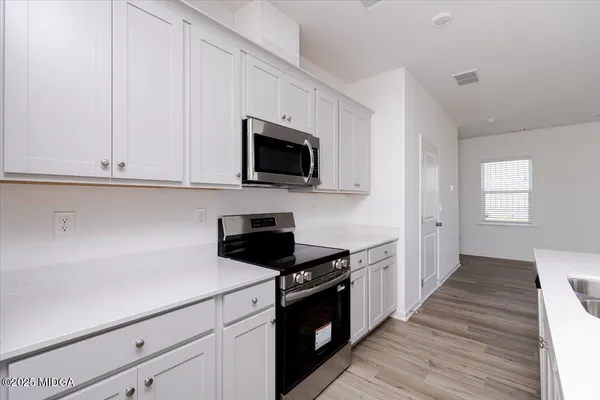 a kitchen with a sink and a stove top oven