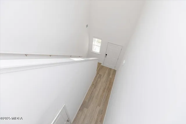 a view of a room with closet and wooden floor