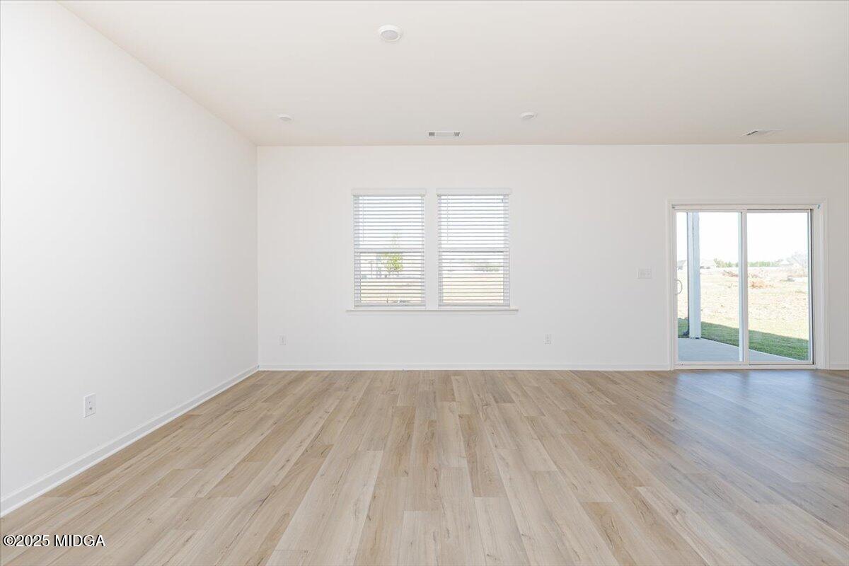 218 Hickory Rdg Trail Kathleen, GA 31047 - Photo 9 of 48 an empty room with wooden floor and windows