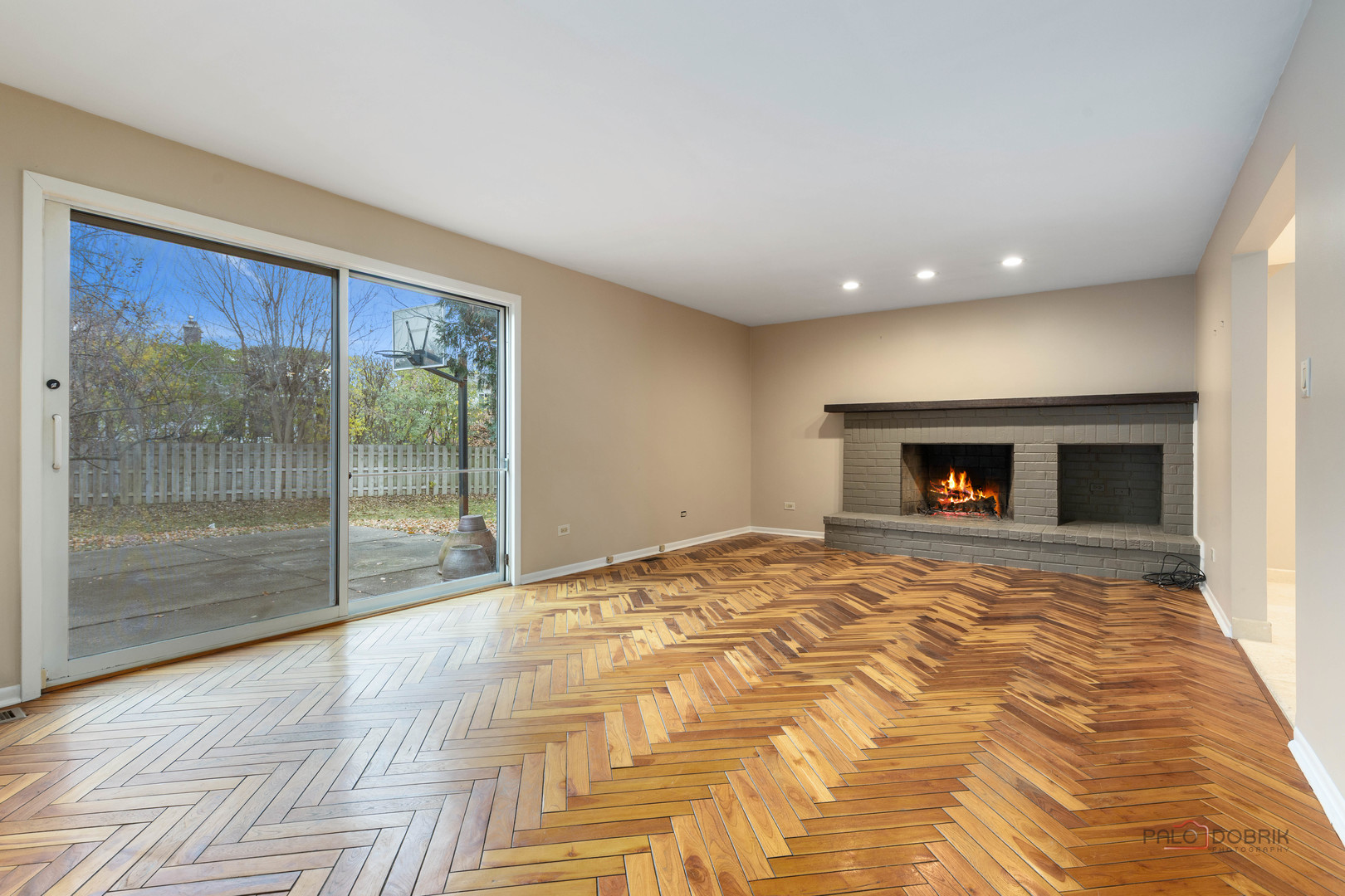 825 Downing Street Northbrook, IL 60062 - Photo 9 of 29 a view of empty room with wooden floor and fireplace