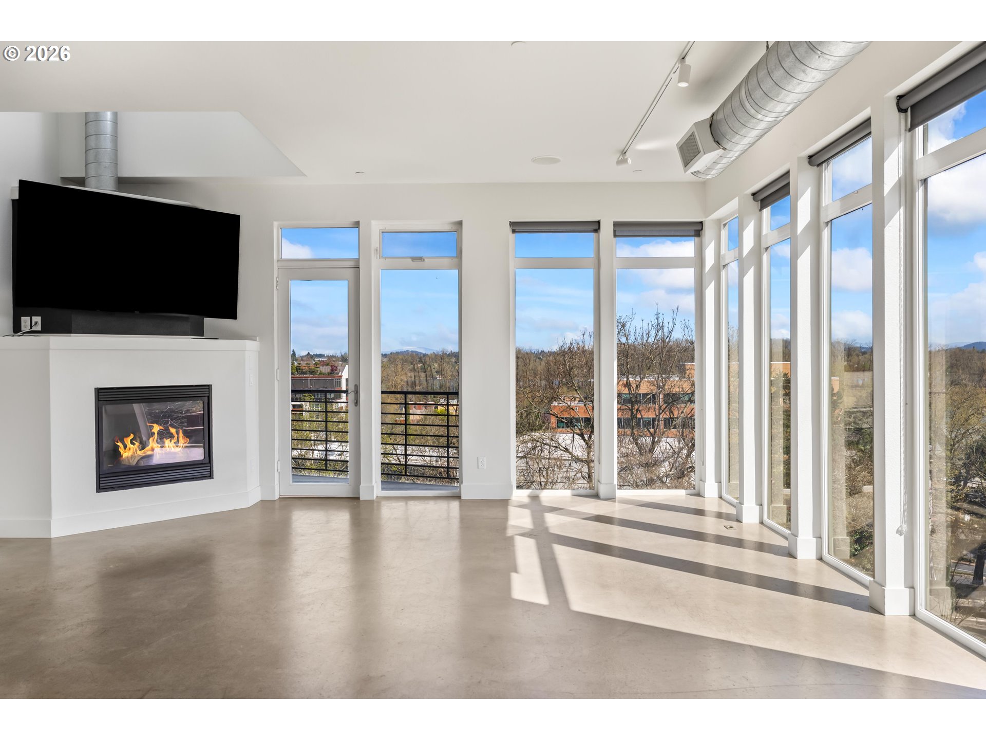 4644 South Kelly Avenue Portland, OR 97239 - Photo 11 of 42 a view of an empty room with a fireplace and a window