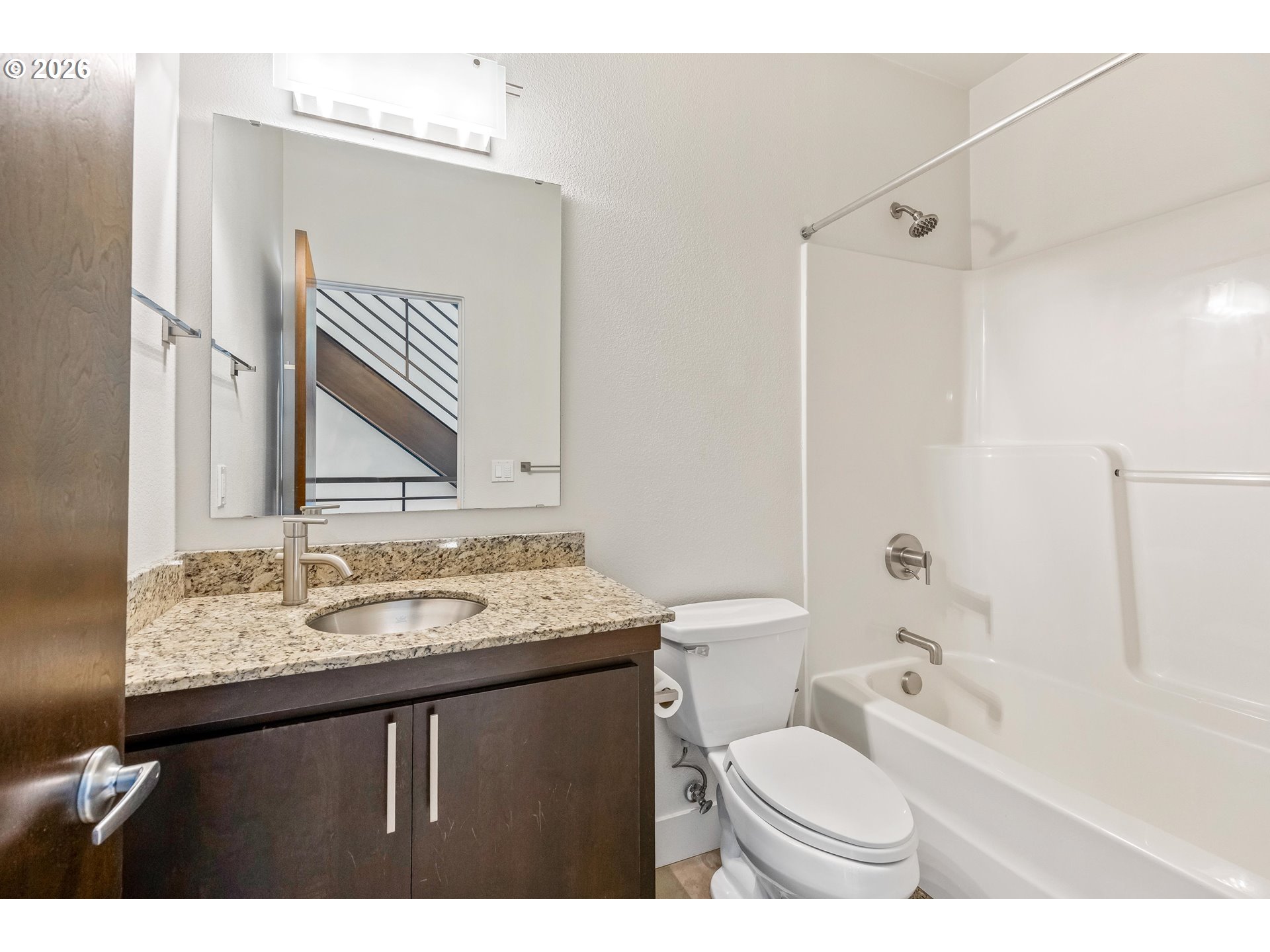 4644 South Kelly Avenue Portland, OR 97239 - Photo 19 of 42 a bathroom with a sink toilet vanity and shower