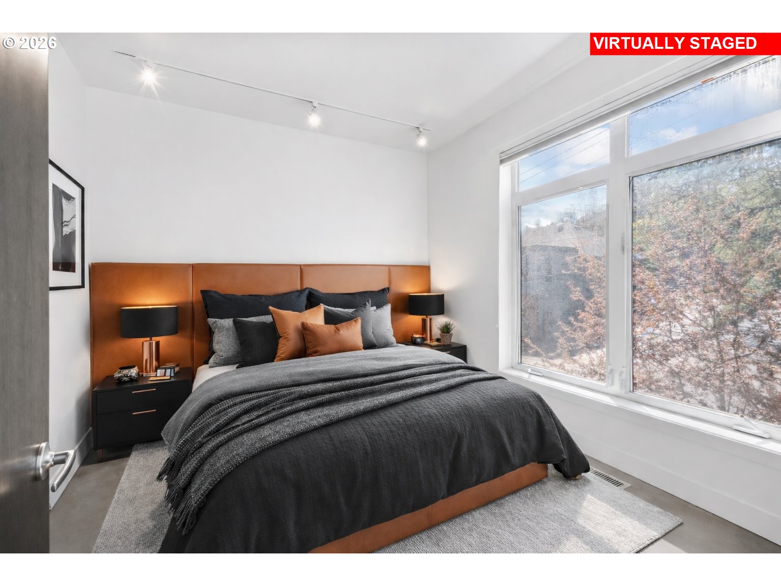 4644 South Kelly Avenue Portland, OR 97239 - Photo 20 of 42 a bedroom with a large bed and a large window
