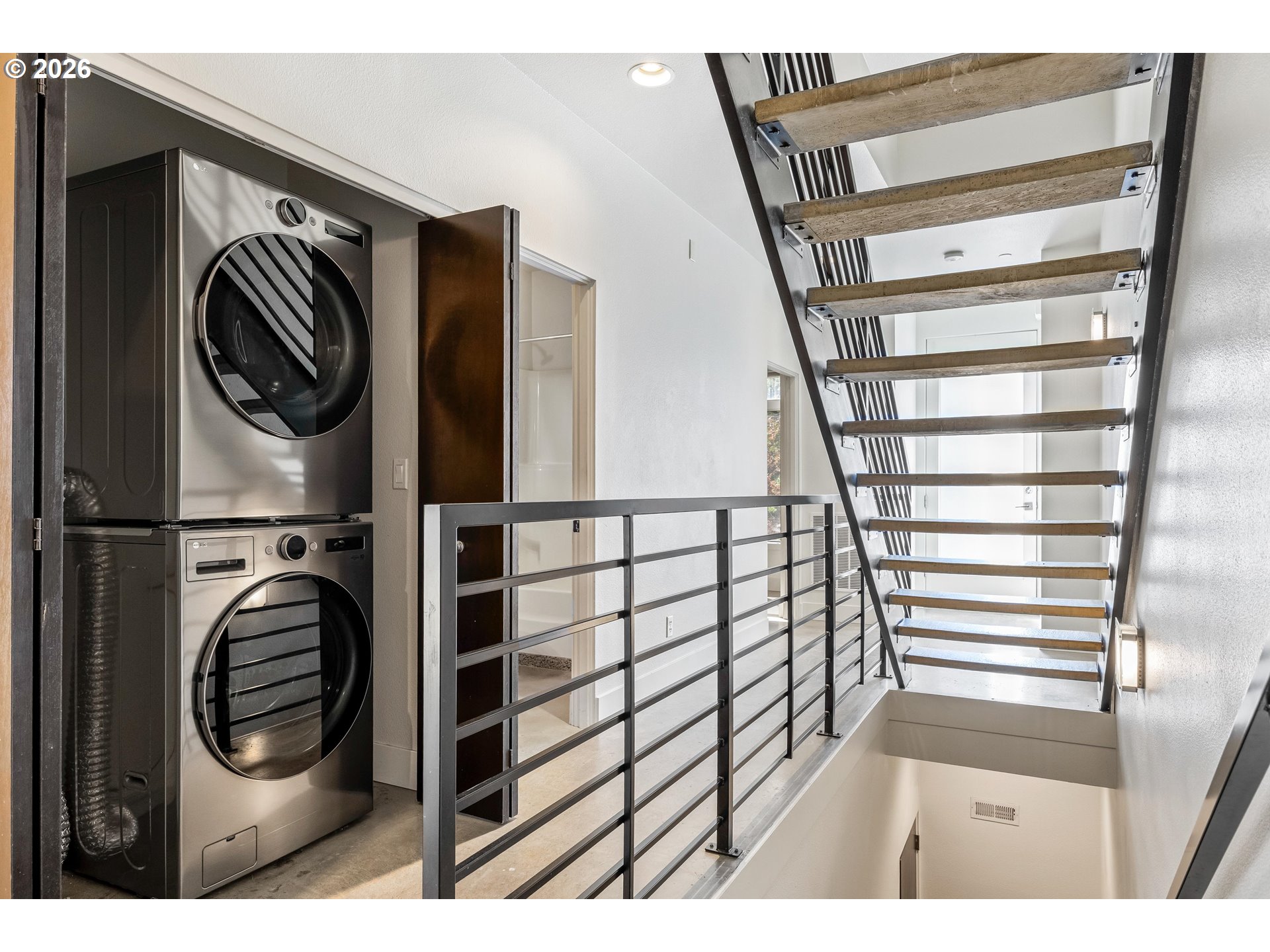 4644 South Kelly Avenue Portland, OR 97239 - Photo 22 of 42 a view of a hallway with washer and dryer