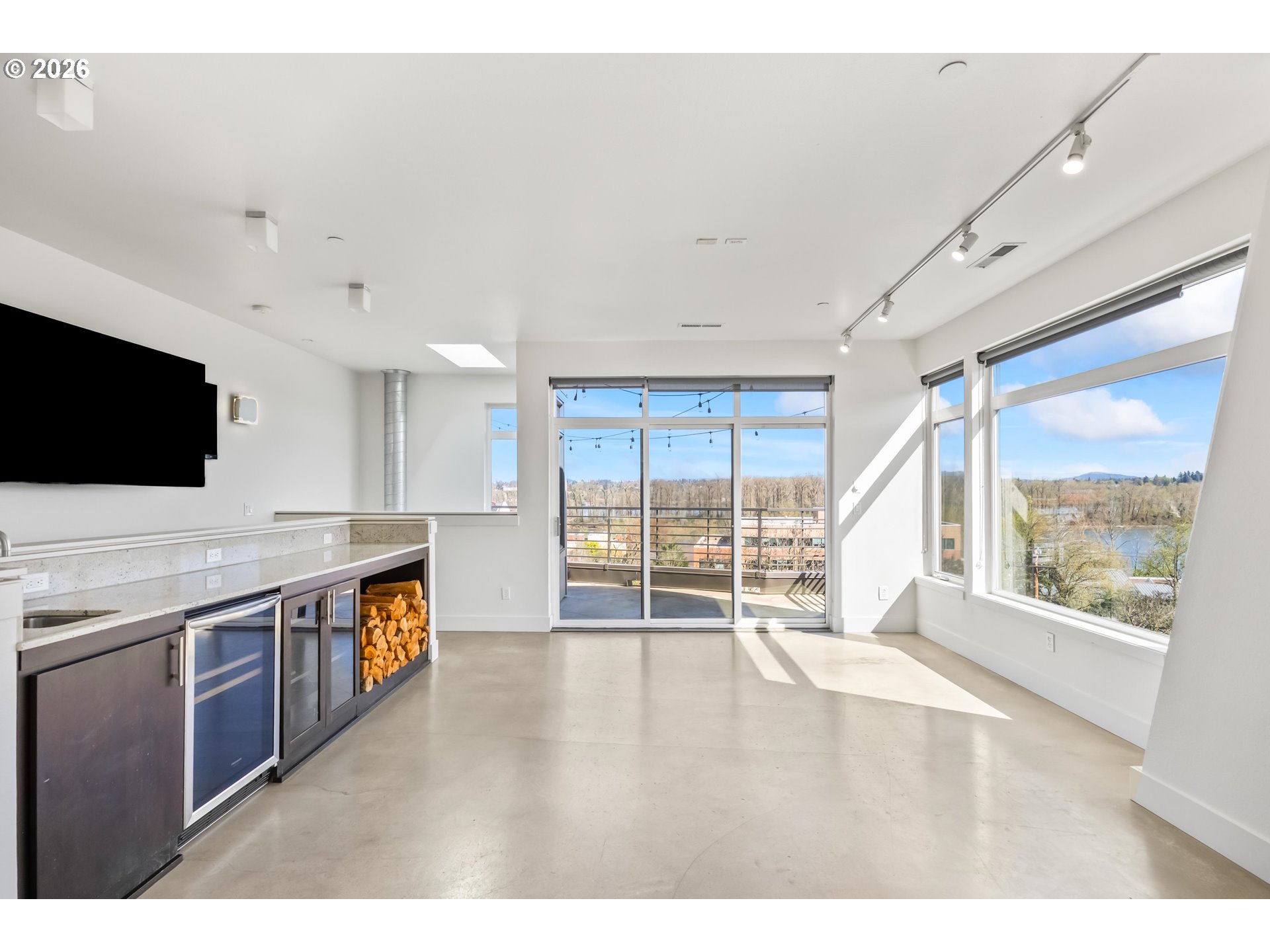4644 South Kelly Avenue Portland, OR 97239 - Photo 25 of 42 a view of an empty room with a window and a kitchen