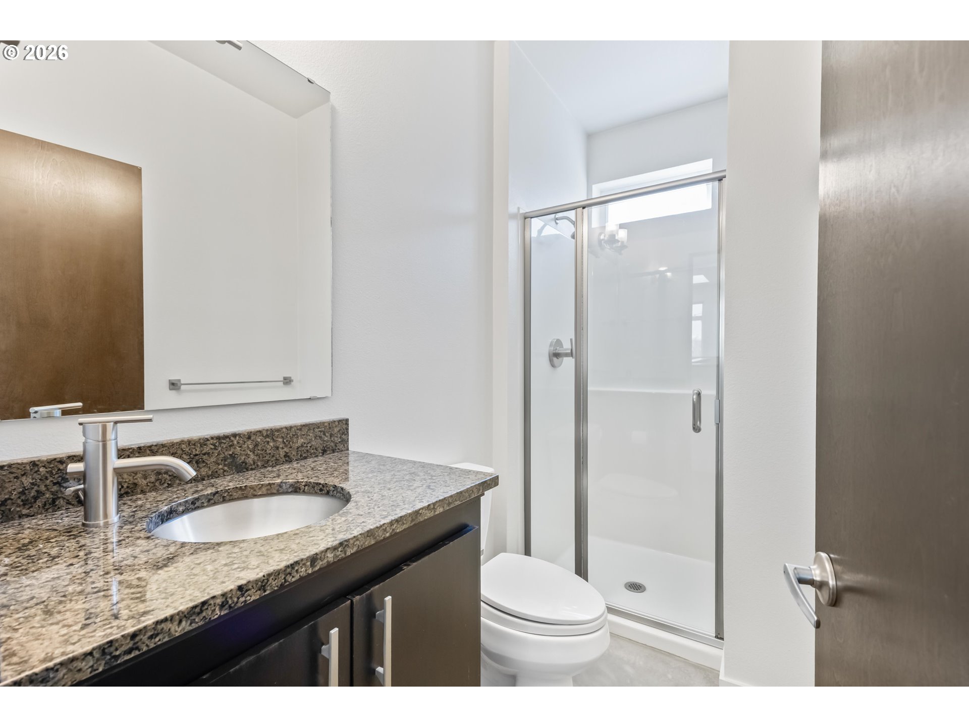 4644 South Kelly Avenue Portland, OR 97239 - Photo 29 of 42 a bathroom with a granite countertop sink toilet and shower