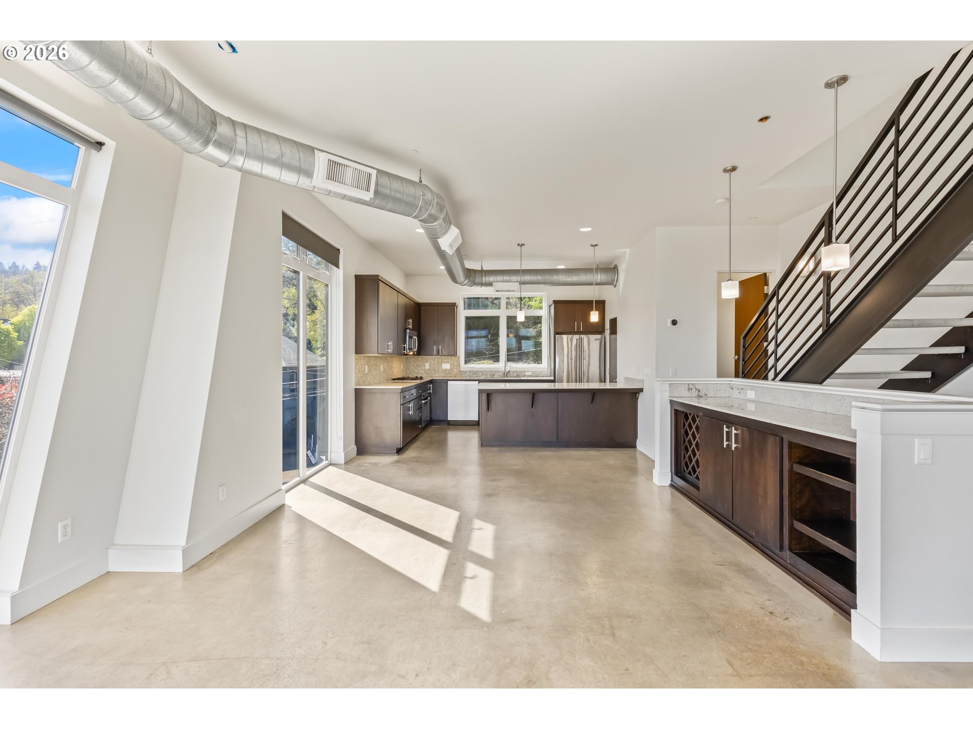 4644 South Kelly Avenue Portland, OR 97239 - Photo 6 of 42 a view of living room kitchen with furniture and a fireplace
