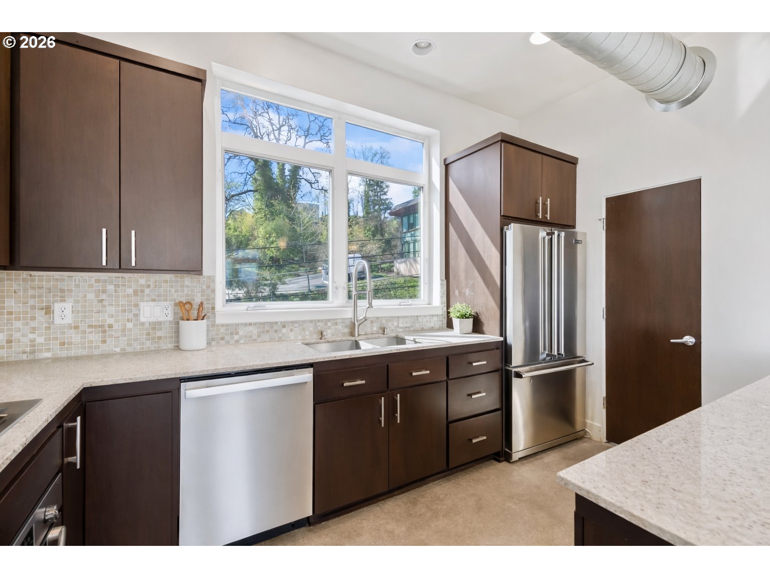 4644 South Kelly Avenue Portland, OR 97239 - Photo 8 of 42 a kitchen with stainless steel appliances granite countertop a sink and a refrigerator