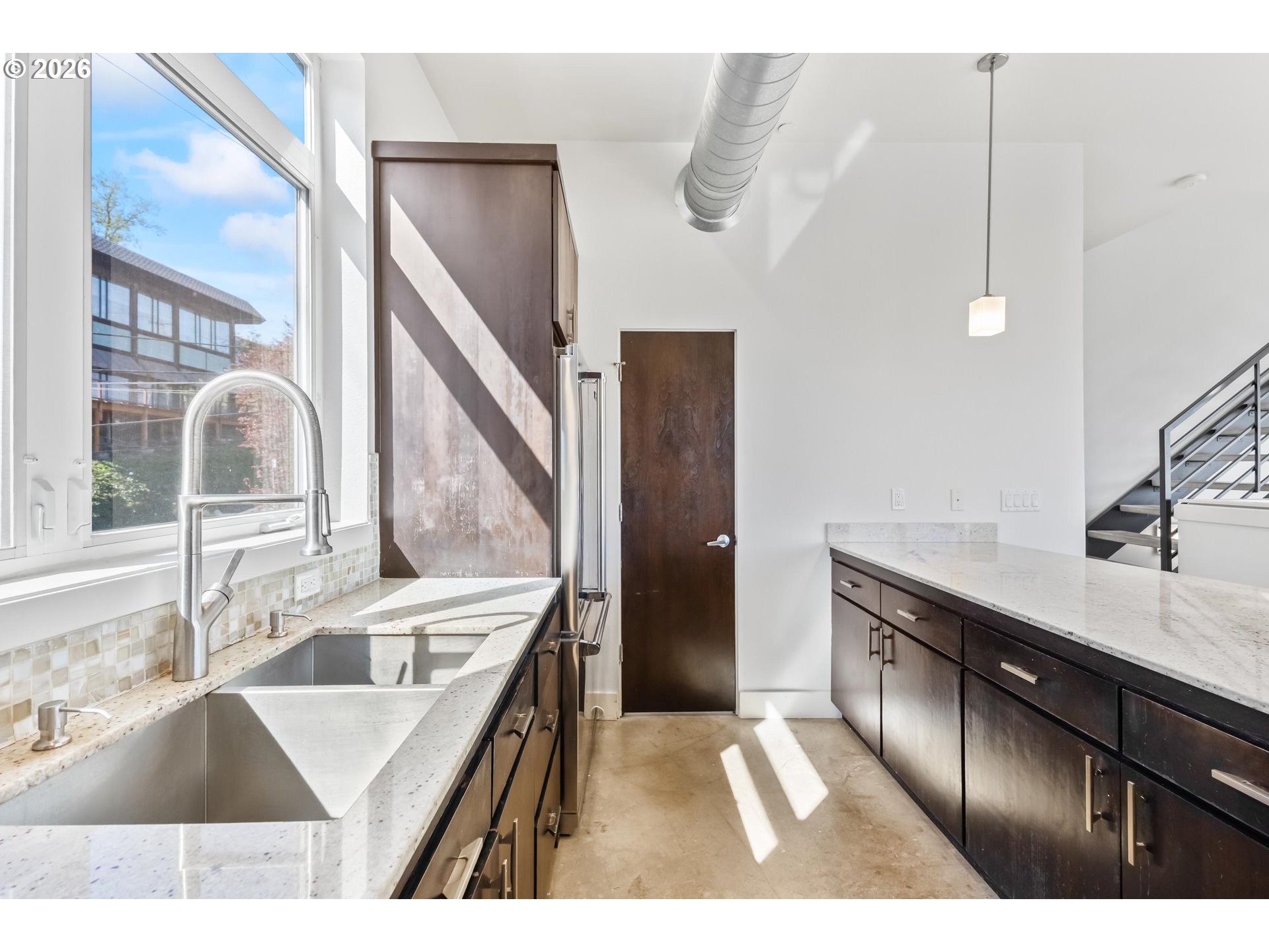 4644 South Kelly Avenue Portland, OR 97239 - Photo 9 of 42 a kitchen with a sink and a refrigerator