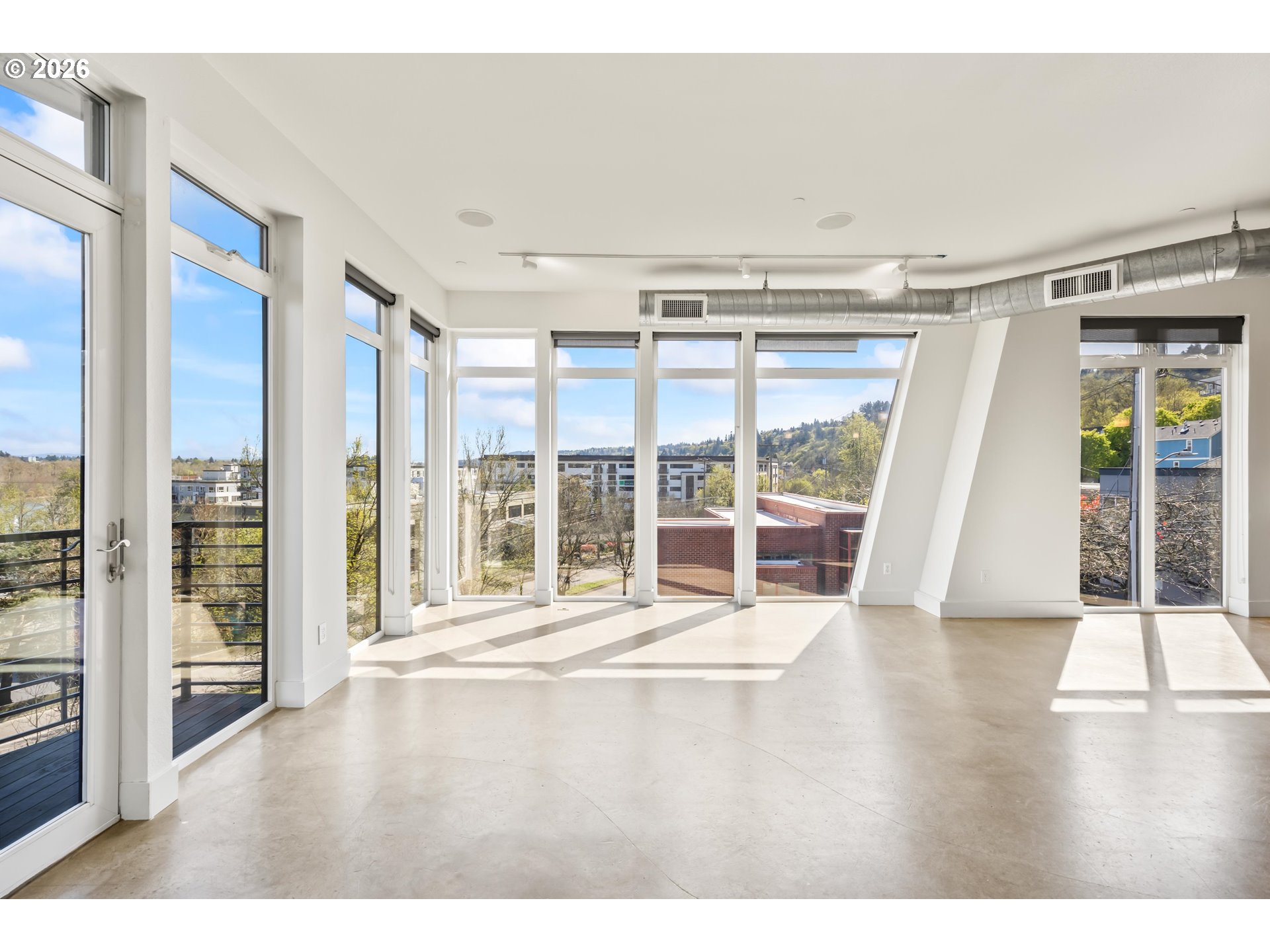 4644 South Kelly Avenue Portland, OR 97239 - Photo 10 of 42 a view of an empty room with wooden floor and a window