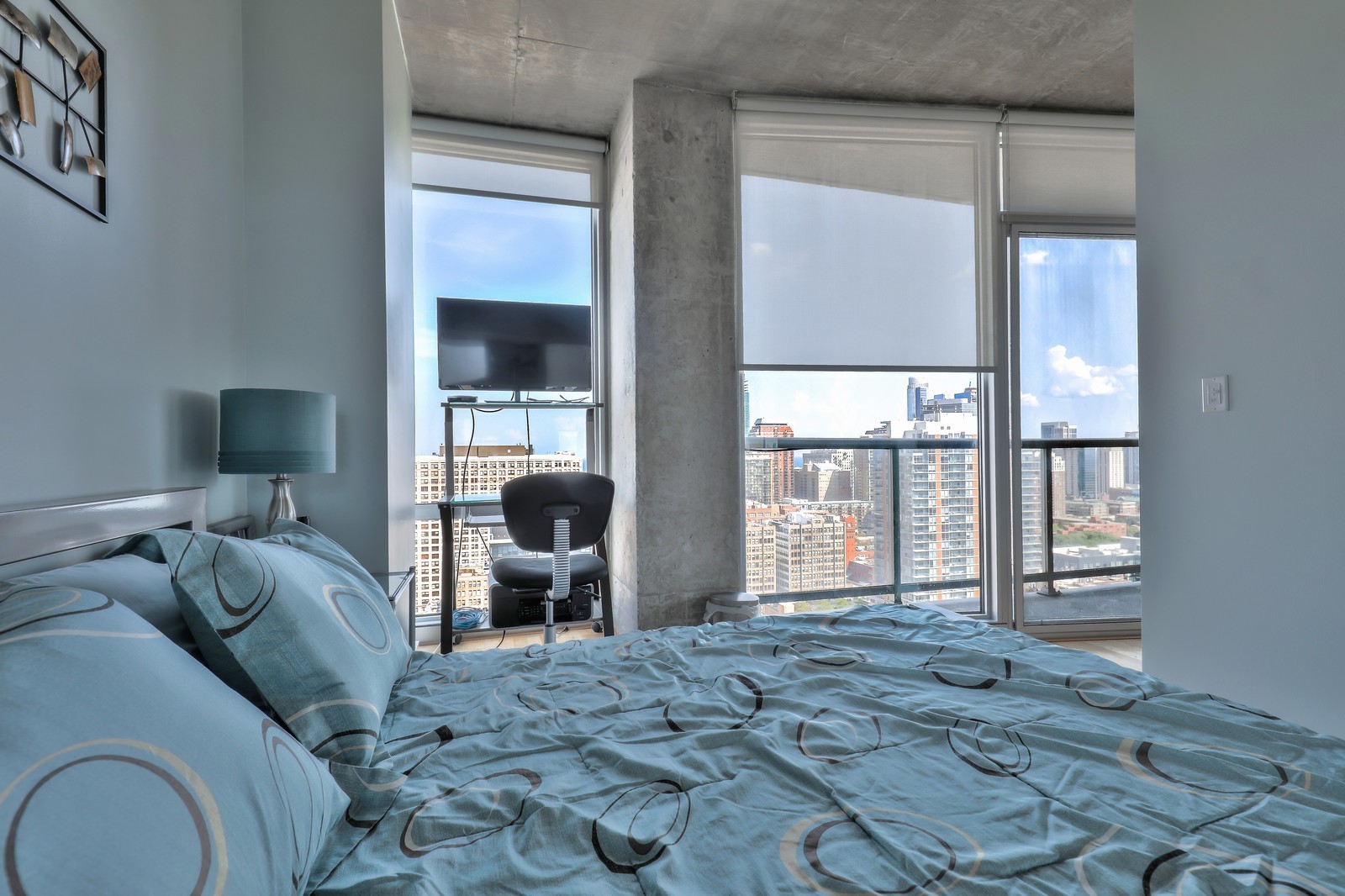 611 South Wells Street, Unit 2808 Chicago, IL 60607 - Photo 11 of 16 a bedroom with a bed and large window