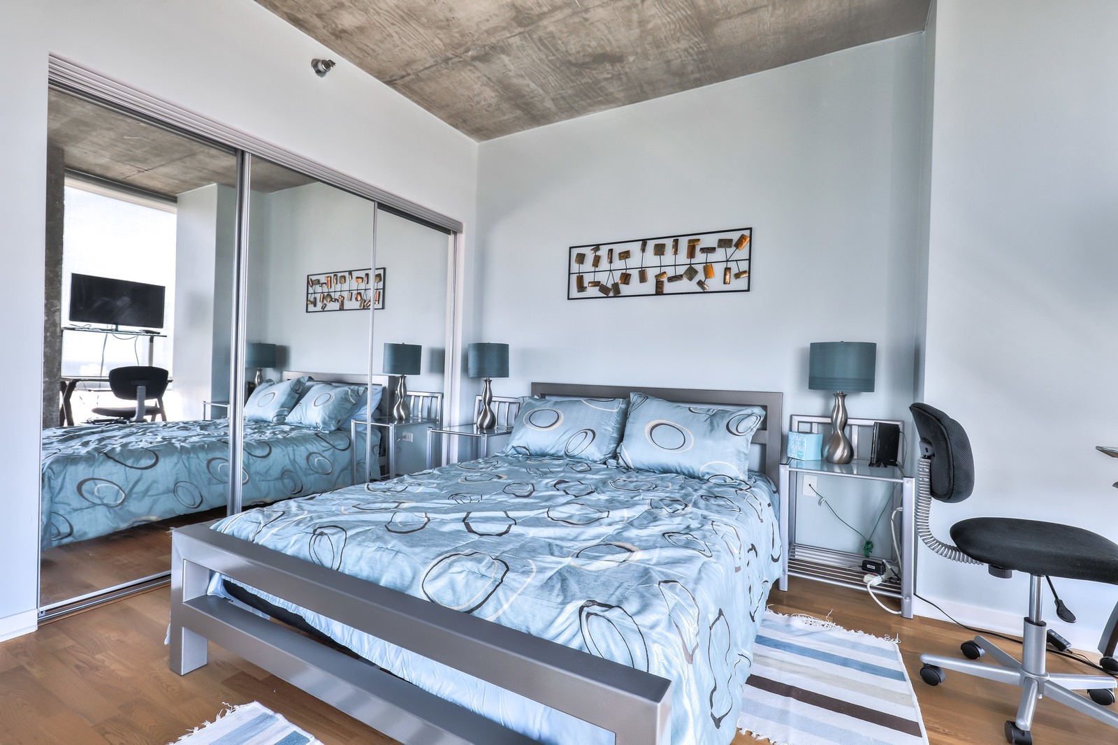 611 South Wells Street, Unit 2808 Chicago, IL 60607 - Photo 12 of 16 a bedroom with a bed and glass table