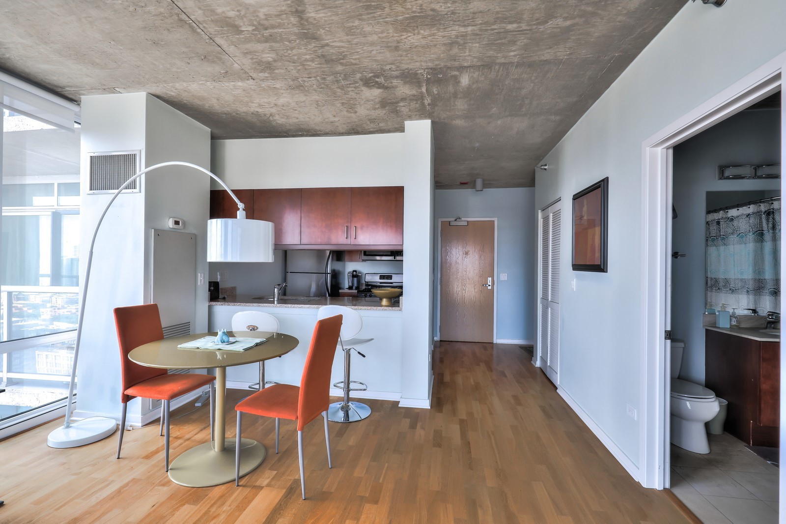 611 South Wells Street, Unit 2808 Chicago, IL 60607 - Photo 3 of 16 a view of a dining room with furniture and wooden floor