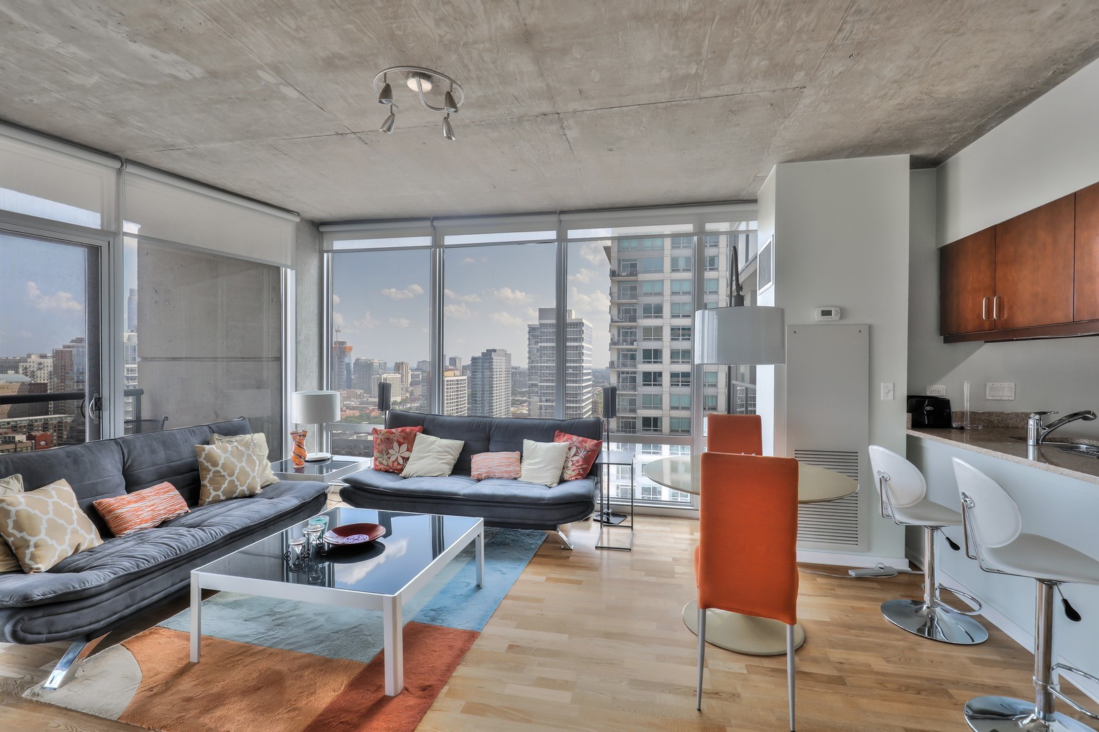 611 South Wells Street, Unit 2808 Chicago, IL 60607 - Photo 4 of 16 a living room with furniture and a flat screen tv